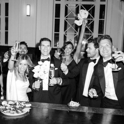 groom's speech black and white image of a wedding party cheers