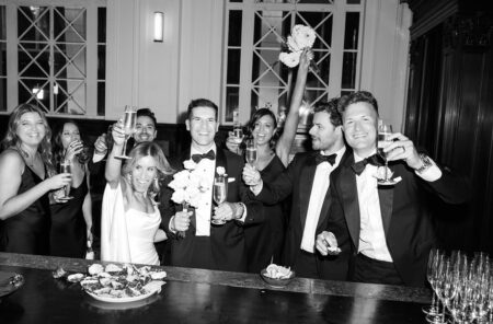 groom's speech black and white image of a wedding party cheers