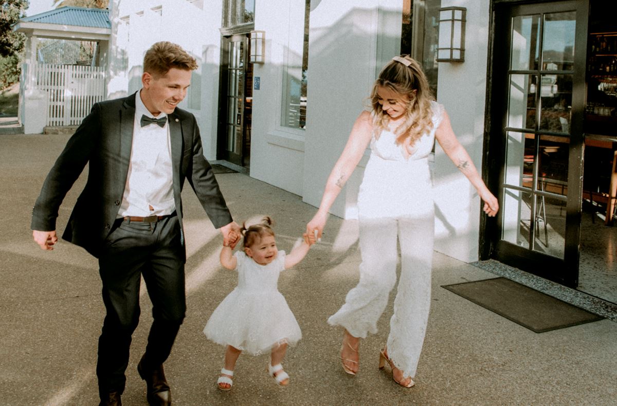 bride and groom with baby girl