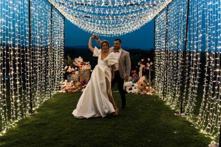 wedding decorations couple under festoon lights