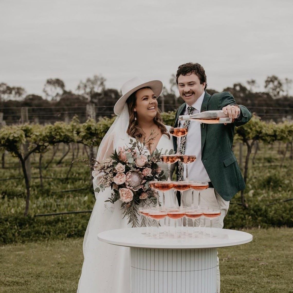 bride and groom under arbour