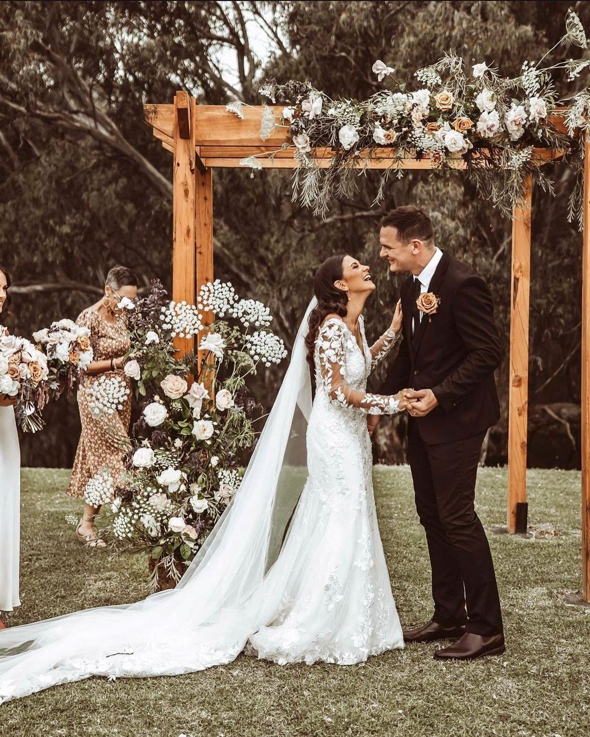 bride and groom under arbour