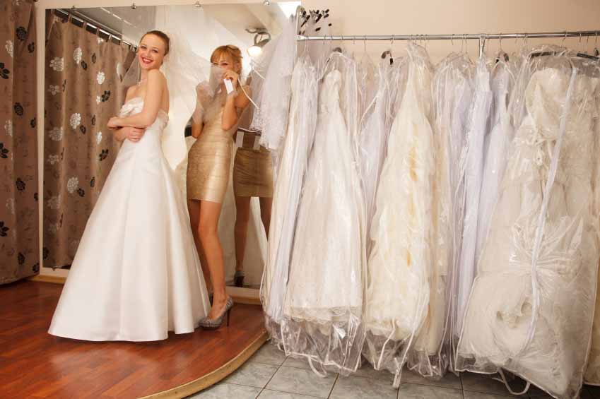 A Bride-To-Be shopping for A Wedding Dress with a girlfriend and having fun in a Bridal Boutique