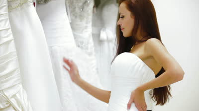 stock footage bride choosing wedding dress in bridal boutique smiling looking at camera1