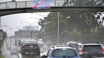 After proposing to Jen on a sign above Melbourne's Nepean Highway, everyone wants to know who Aussie Dave is - and why Jen's leaving. Image: Jay Town (Leader)