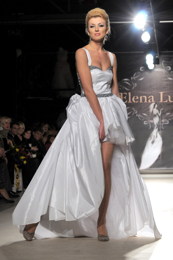 Sexy and powerful, this Elena Luka gown is short in the front and long in the back, and combines sharp white with silver, a powerful and sexy combination.