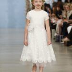 Abigail: Ivory Chantilly lace gown with illusion tulle neckline and trumpet godet skirt. Oscar de la Renta.