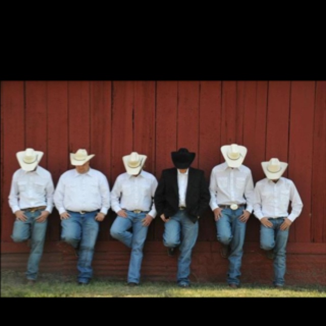 A groom and his groomsmen in cowboy hats