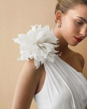 wedding dress with a white flower on shoulder