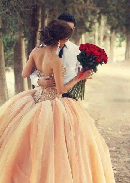 wedding dress and a bouquet of red roses