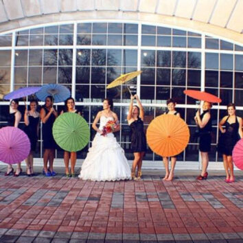 brides pose with parasols