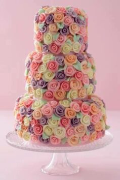wedding cake covered in multi-colour roses