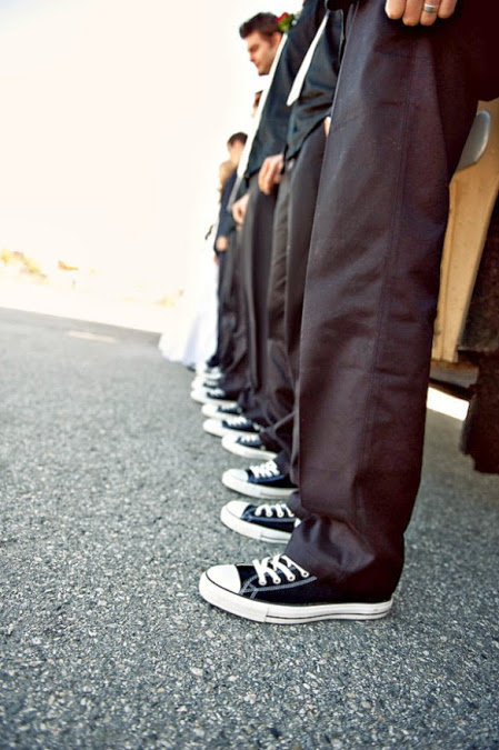 groomsmen in sneakers and black suits