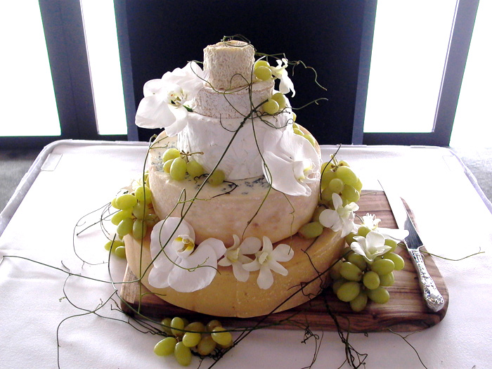 A sophisticated take on the humble cheese platter, this cheese wheel comes complete with grapes and gorgeous blooms. All that’s missing are the crackers. Image: Formaggi Ocello
