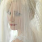 Pretty as a picture, Angela makes a stunning bride, even from behind her traditional veil