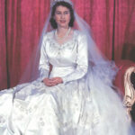 Princess Elizabeth poses in her wedding gown in the Throne Room of Buckingham Palace hours after her wedding ceremony