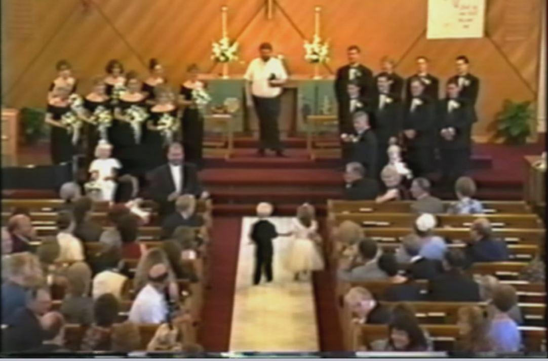Briggs and Brittany head down the aisle for the first time in 1995 as a flower girl and page boy for the same wedding. Image: Fox 9.