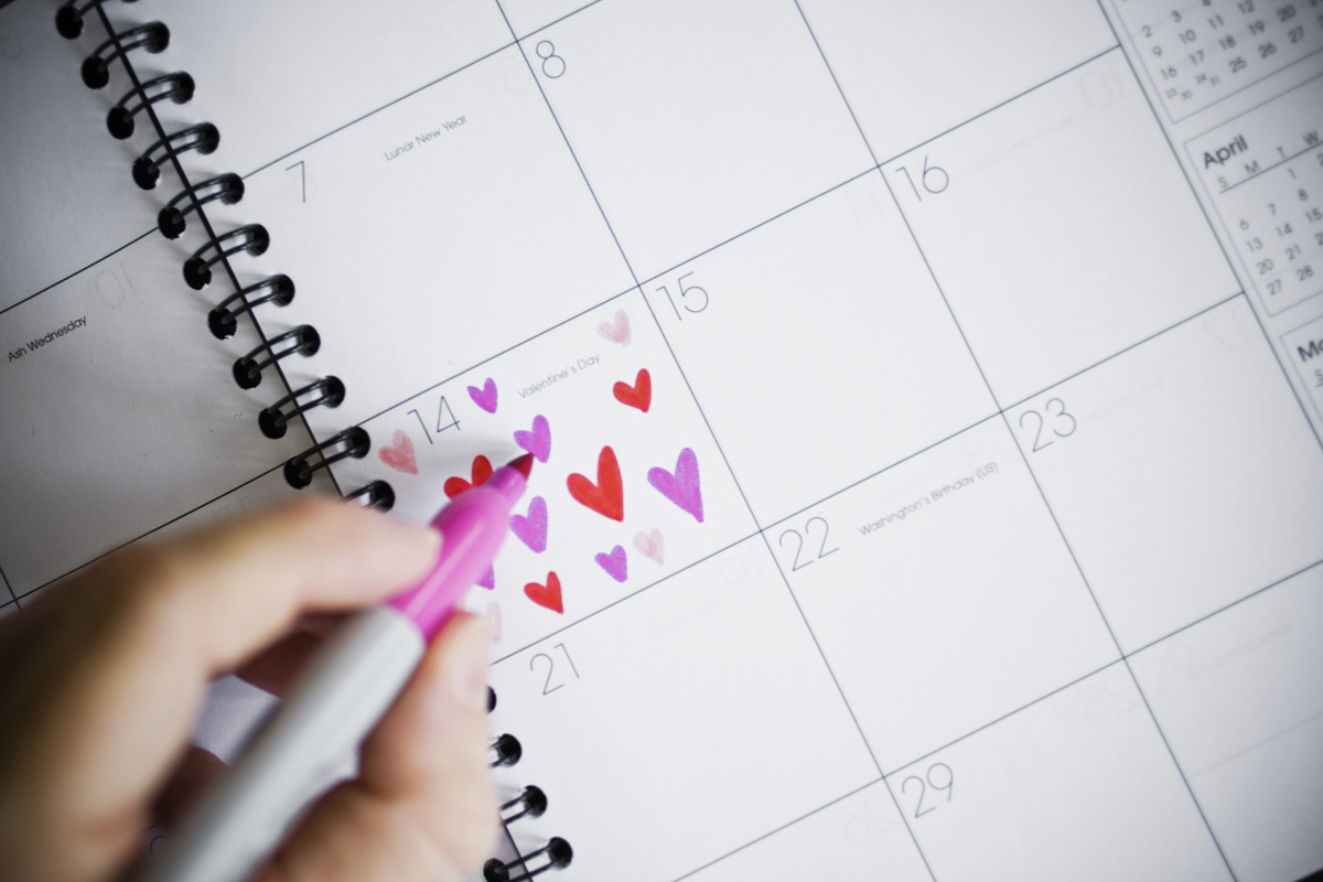 Woman Marking Valentine's Day on a Calendar