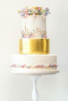 White wedding cake with a golden band