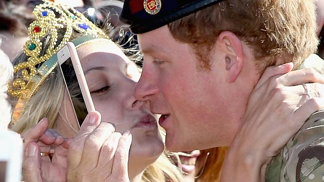 Marry me: Prince Harry stuns Sydney super fan with a kiss