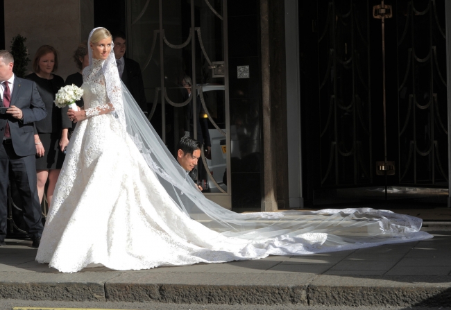 The bride emerges from her hotel wearing her $100,000 Valentino wedding gown.