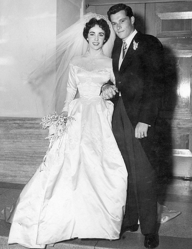Elzabeth (Liz) Taylor in elaborate white ivory wedding dress at ceremony to marry Conrad Hilton 1950s