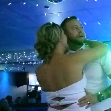 groom can't resist watching the rugby - during his first dance at his wedding