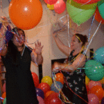 The girls enjoy playing with the balloons
