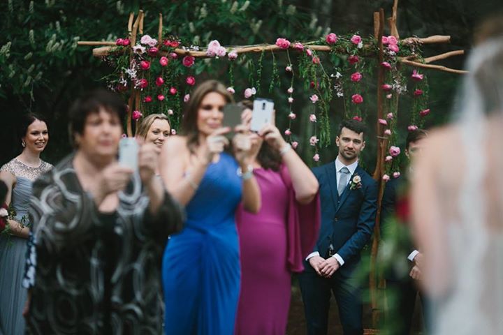 This photo, by Thomas Stewart Photography, shows a groom struggling to see his bride walking up the aisle – and it perfectly sums up our bride’s concerns about guests taking photos with their mobile phones during her wedding ceremony.