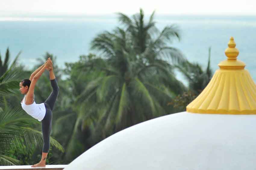 woman doing yoga on the rooftop in thailand