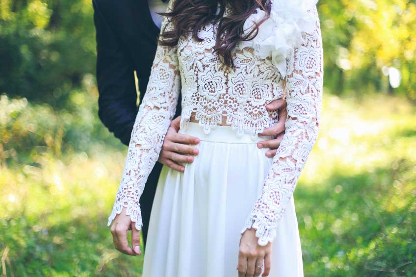 Groom hugging bride