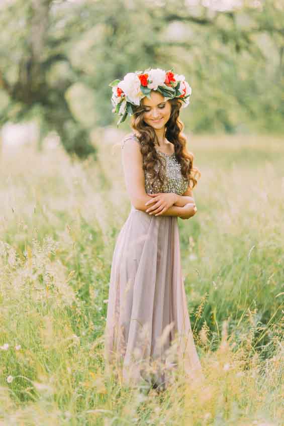 Portrait of beautiful charming young lady in flower wreath and