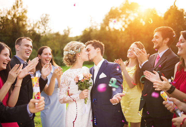 Newlyweds with guest on their garden party