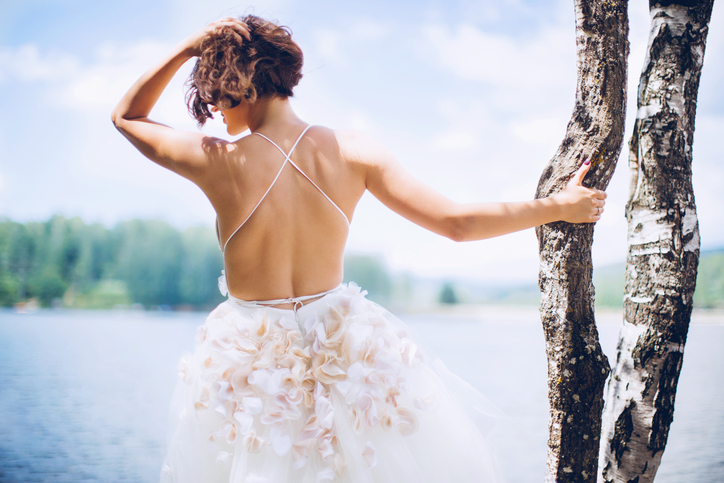 Stunning bride with beautiful wedding dress by the lake