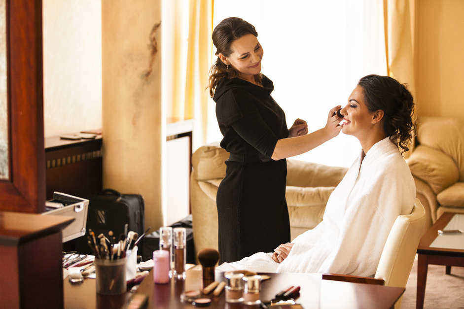 Make-up artist applying wedding makeup