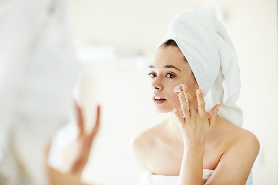 Girl applying moisturiser, wedding makeup