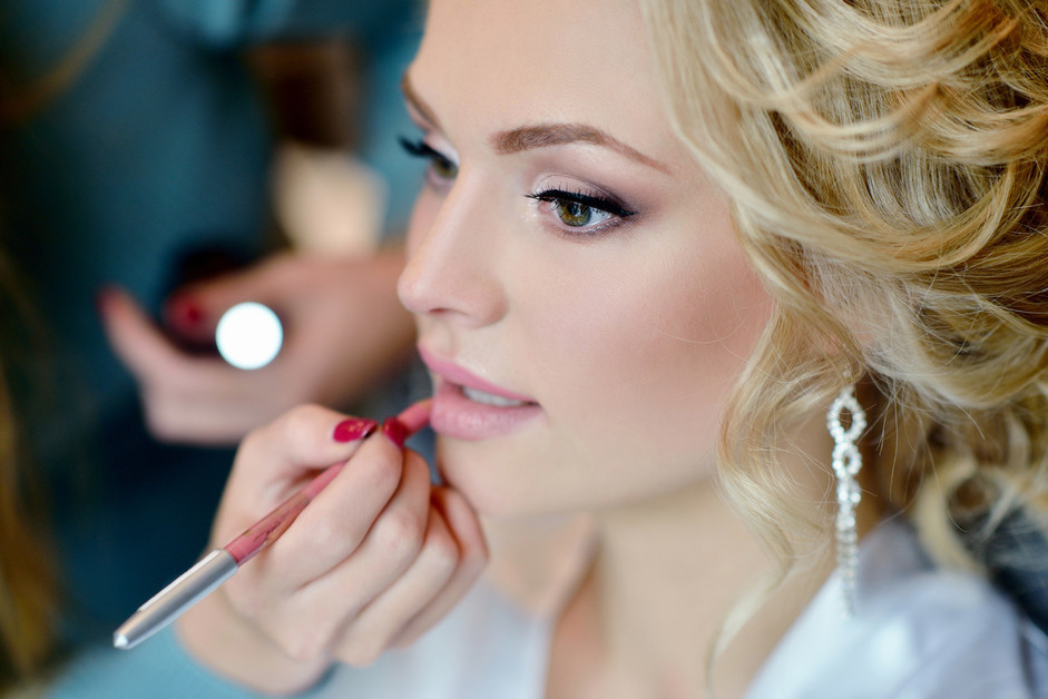 Wedding makeup artist making a make up for bride