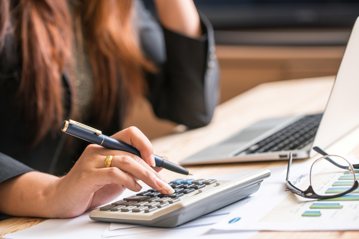 Close up of female accountant or banker making calculations. Sav