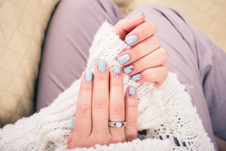 beautiful manicure. Gel polish coating in blue, embossing.