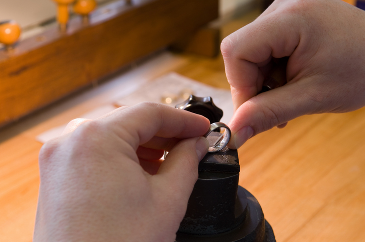 Engraver, engraving a writing into a ring, close-up