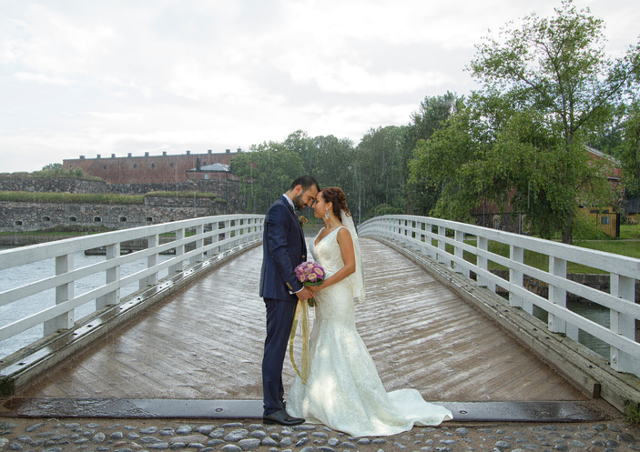 Romantic wedding couple standing on pier