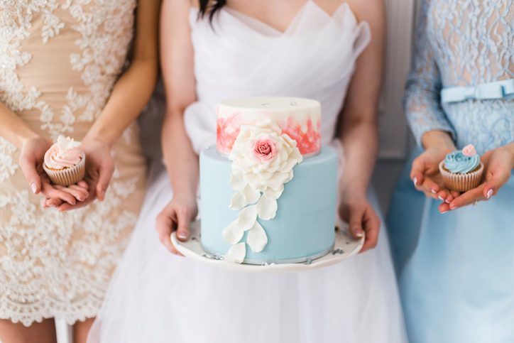 Bride holding a beautiful wedding cake