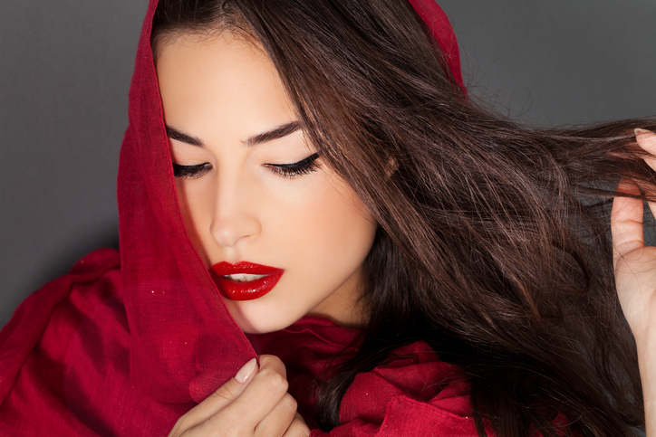 a woman in a bright red scarf