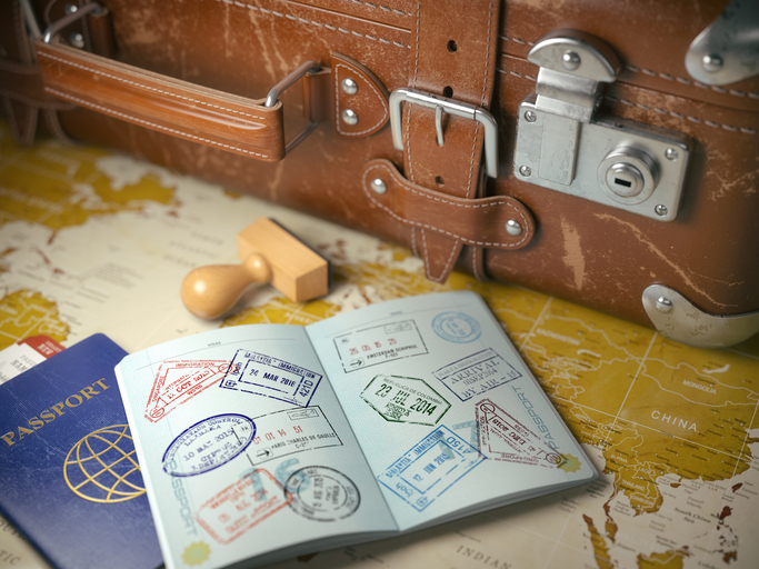 Travel or turism concept. Old suitcase with opened passport