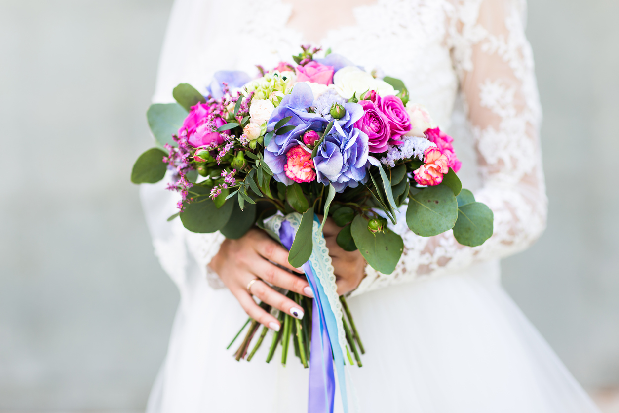 Wedding flowers ,Woman holding colorful bouquet with her hands on wedding day.