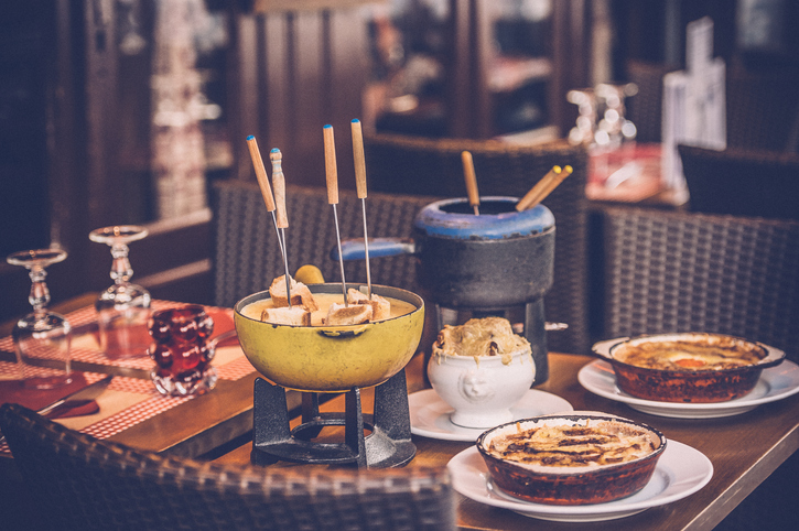 Parisian street cafe with an earthenware pot (caquelon) for fondue