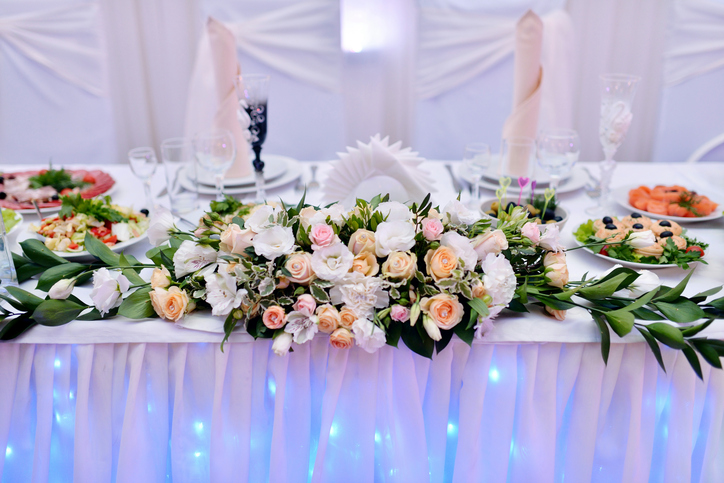 Beautiful wedding restaurant for marriage. White decor for bride and groom. Colorful decoration for celebration. Beauty bridal interior. Bouquet, food and flowers in hall