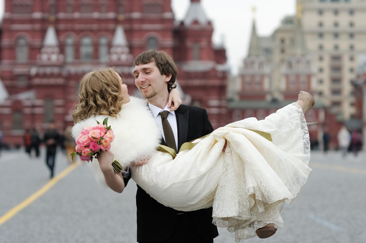 Groom holding bride in his arms