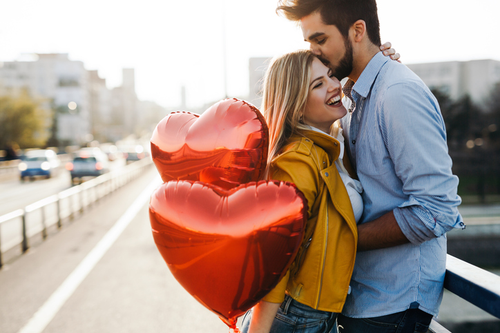 Romantic young couple in love, hugging on the street on valentine day