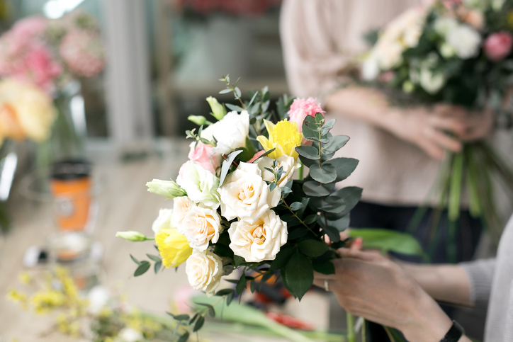 Workshop florist, making bouquets and flower arrangements. Woman collecting a bouquet of flowers. Soft focus